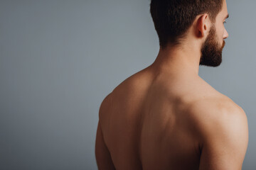 closeup shot of male back during twisting motion emphasizing muscles and flexibility