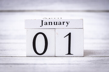 Handcrafted block calendar displaying January 01 on a textured wooden background. Ideal for representing new beginnings, celebrations, and annual events.