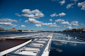 Sailing along the Neva River, St. Petersburg. Water tourism, view from a boat.