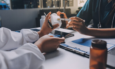 Group of doctors attending seminar in hospital lecture hall with senior physician giving medical presentation and professional training session on healthcare practices