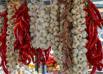 Garlic and peppers hanging on market stall