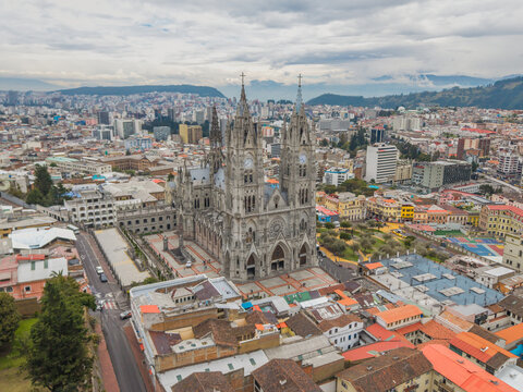 Aerial view of the magnificent Bas&iacute;lica del Voto Nacional pierces the sky amidst a sprawling urban tapestry, a gothic masterpiece standing tall, Quito, Ecuador.