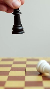 Man playing chess defeating his opponent. Business or political victory. Vertical video.
