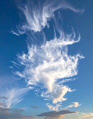 Wispy cirrus clouds drift across a vibrant blue sky.