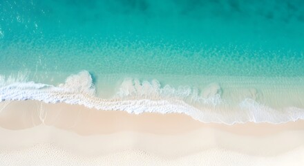 Obraz premium Drone view of a white beach with a light blue sea, as if divided into two sides, the sea side and the beach side.