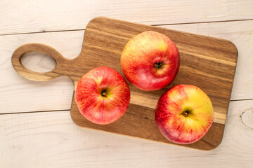 Juicy sweet apples on a wooden table, top view, macro.