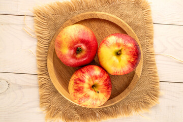 Juicy sweet apples on a wooden table, top view, macro.