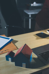 Customer signing a real estate contract in real estate agency.