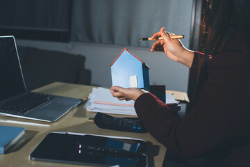 Customer signing a real estate contract in real estate agency.