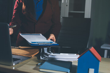 Customer signing a real estate contract in real estate agency.