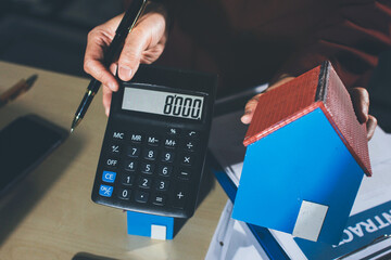 Customer signing a real estate contract in real estate agency.