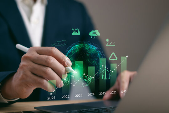 Closeup of businessman using digital pen on a timeline bar chart showing sustainable growth and eco goals from 2021 to 2050. Concept of green strategy, climate action and carbon neutral target