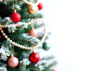 Fototapeta premium Festive Holiday Christmas Tree with Colorful Decorations, Pearls, and Snow-Dusted Branches, White Background, Cheerful Composition