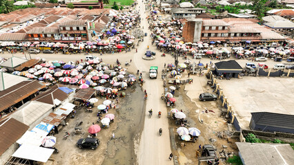 Aerial view of bustling market streets teeming with life, where vibrant umbrellas dot the landscape amidst the buildings, Eleme, Rivers, Nigeria.