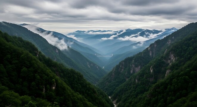 Misty mountain valley with dramatic clouds