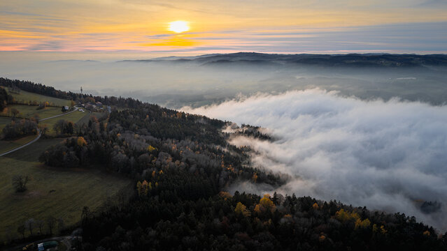 Golden sunset over the Bavarian Forest and Straubing Bogen district with fog in the valleys glowing in warm evening light across Bavaria Germany