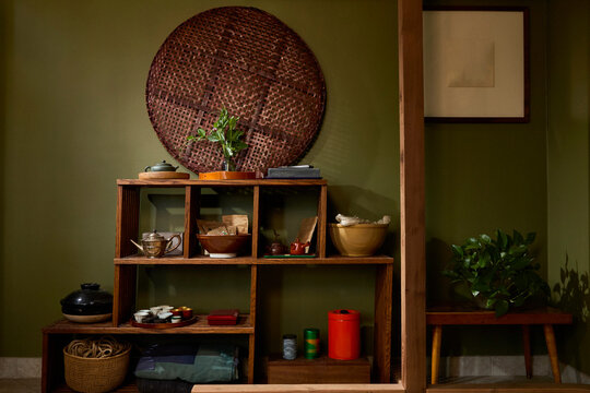 Interior of Japanese style shelf with basket, tea and tea related items.