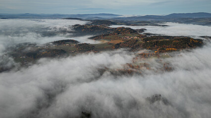 Magical sunset over the Bavarian Forest near Straubing Bogen as fog wraps the hills and golden light touches the autumn trees across Bavaria Germany