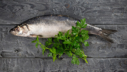 Fresh Herring on Rustic Wooden Background with Parsley