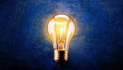 illuminated idea glowing light bulb on a dark blue textured background