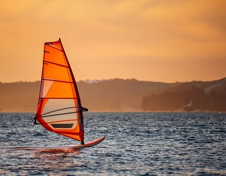 orange windsurfing sailboard ready for action