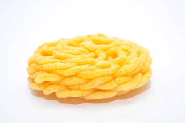 A bright yellow, intricate fried Indonesian cracker with a woven spiral pattern, isolated on a clean white background. Represents crispy traditional Asian snack food, unique culinary textures.