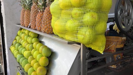 fresh pineapples and sweet lime fruits displayed at roadside juice stall - Powered by Adobe