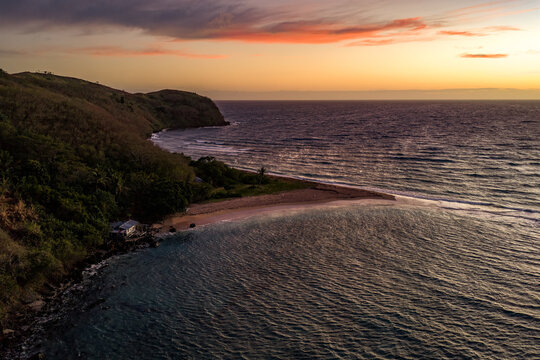 Aerial view of the tranquil shorelines of Yasawas Islands meet the tranquil ocean under the soft hues of the dawn sky, Nadi, Western Division, Fiji.