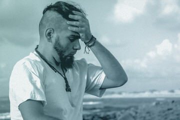 A thoughtful man holding his head on the beach with artistic halftone texture