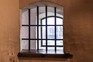 Fototapeta premium Old castle interior with antique furniture, stone walls, and warm light creating a medieval atmosphere full of history and mystery.