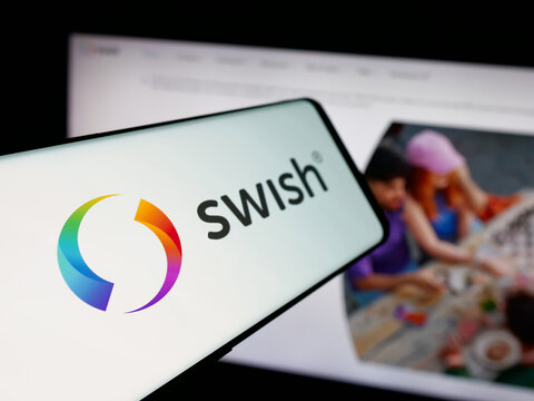 Stuttgart, Germany - 11-03-2025: Smartphone with logo of Swedish fintech company Swish (Getswish AB) on screen in front of website. Focus on center-left of phone display.
