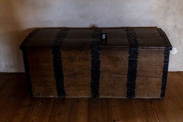 Old wooden chests with metal fittings placed in a medieval castle interior, showing antique craftsmanship, aged textures, and historical ambiance.