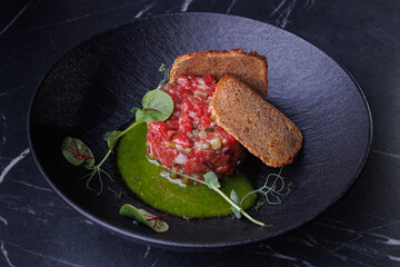 Gourmet Beef Tartare With Crispy Crostini and Fresh Greens