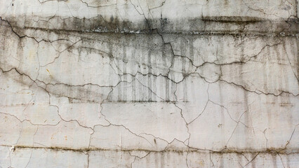 Fototapeta premium Close-up texture of a gray concrete wall with prominent cracks and scratches. Ideal background for grunge, industrial, decay, renovation, construction, and abstract concepts. Horizontal copy space.