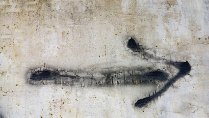 Hand-painted black arrow graffiti on a rough, dirty concrete wall, pointing right. Concepts of direction, decision, choice, navigation, signpost, urban art, texture, and ample horizontal copy space.