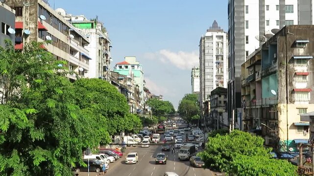 Bust street with traffic and Sule Pagoda in Yangon, Myanmar