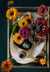 Overhead informal floral tray arrangement with zinnias and succulents