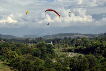 Paragliding over the clouds at Bir Billing Himachal Pradesh India. Clouds in the sky, Dhauladhar peaks view