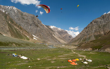 Tourists paragliding 3 pm 6 june 2025 at Leh Ladakh with view of Himalayan mountain range.