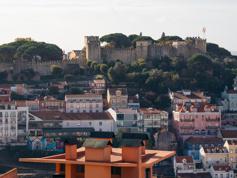 View of the imposing São Jorge Castle perched atop a hill overlooking colorful buildings, a captivating display of history and architecture, Lisbon, Lisbon, Portugal.