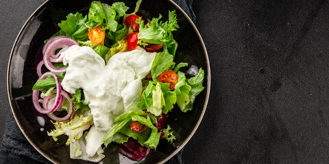 Burrata salad tomato, purple onion, green leaf lettuce tasty snack fresh gourmet food table setting rustic food top view copy space keto and paleo diet vegetarian food