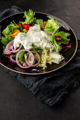 Burrata salad tomato, purple onion, green leaf lettuce tasty snack fresh gourmet food table setting rustic food top view copy space keto and paleo diet vegetarian food