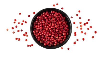 Pink peppercorn  pepperberry  in black bowl flying isolated on white background. Aromatic spicy ingredient for cuisine