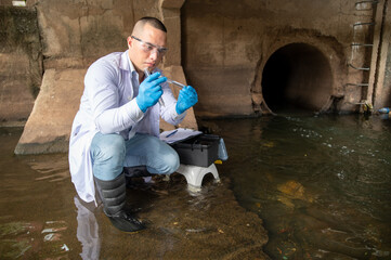 Scientist collected water samples from the drainage tunnel placed them in test tubes and examined it