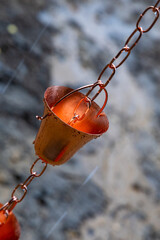Close-up. Gutter chain. Decorative rainwater collector on a rainy day.