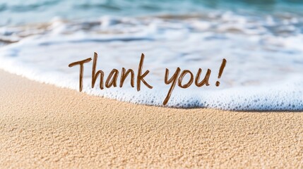 Fototapeta premium Handwritten thank you message on soft sand along an exotic beach with gentle waves and warm sunlight illuminating the scene