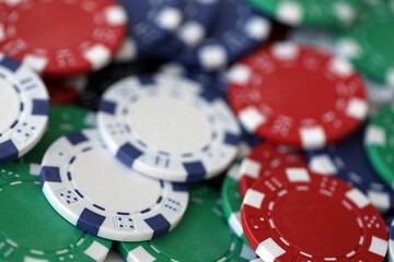 Close up of a group of casino chips on a green mat for poker or dice games indoors