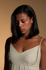 woman with flowing hair and tears on clean solid background conveying deep emotion