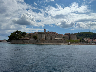 Historic European Coastal Town Under Dramatic Cloudy Sky