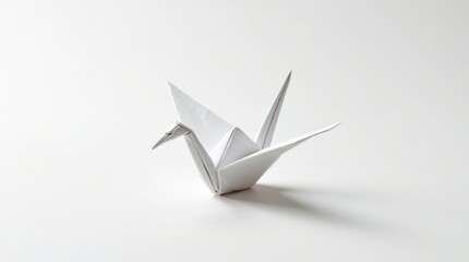 Minimalist white origami crane on a clean white background